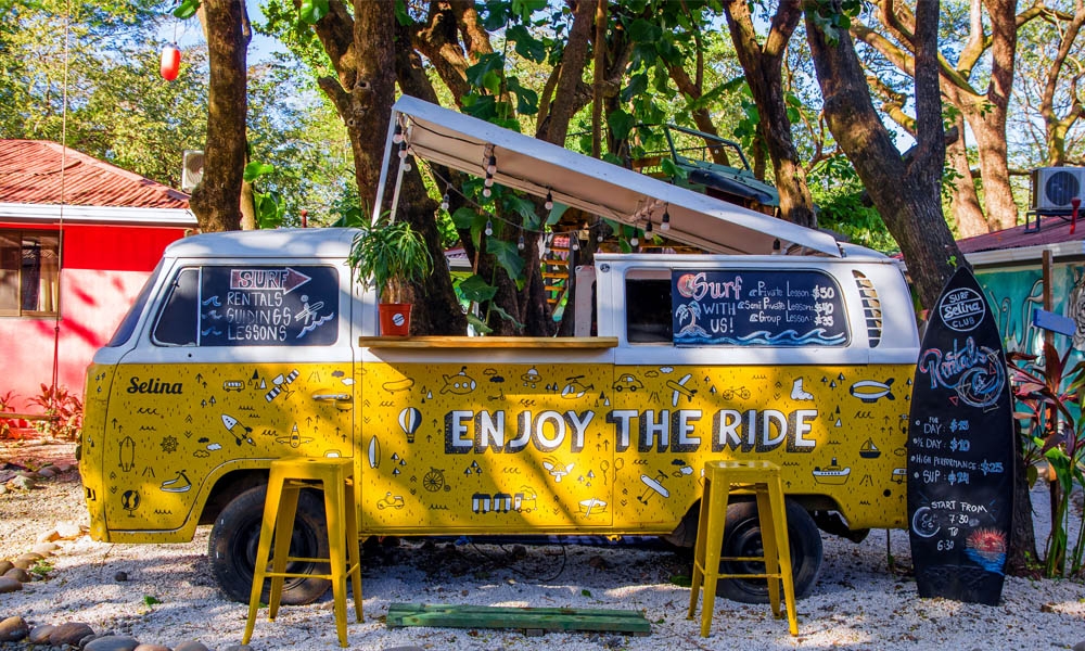 Outdoor view of yellow van parked at outside of a building hostal